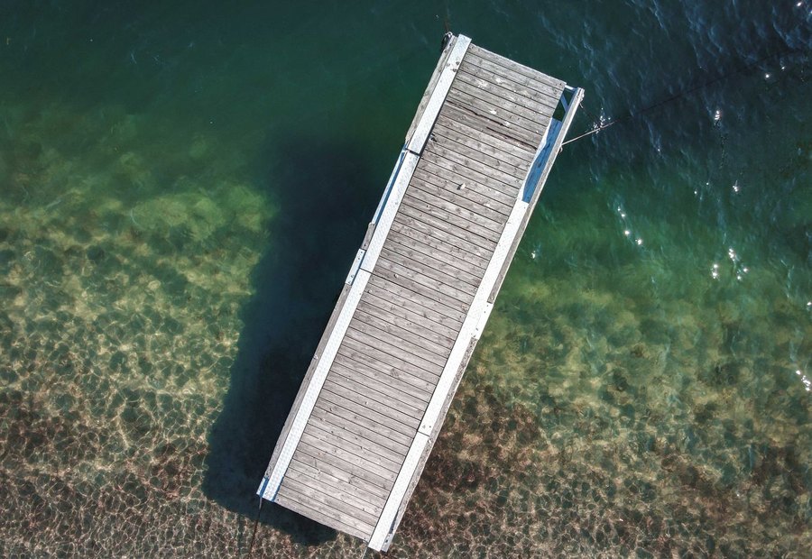 Fresh composite dock decking replacing weathered boards on a floating dock