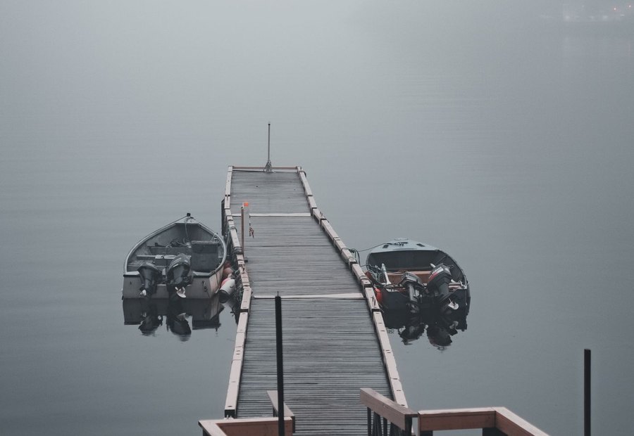 Inspector checking dock cables and flotation against shoreline permit requirements